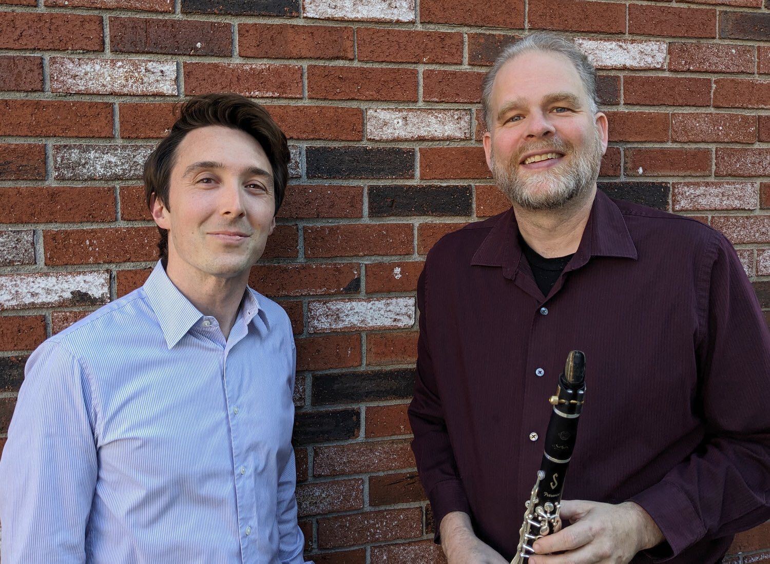 Photograph of the performers, Solon Gordon and Jonathan Russell, standing in front of a brick wall.